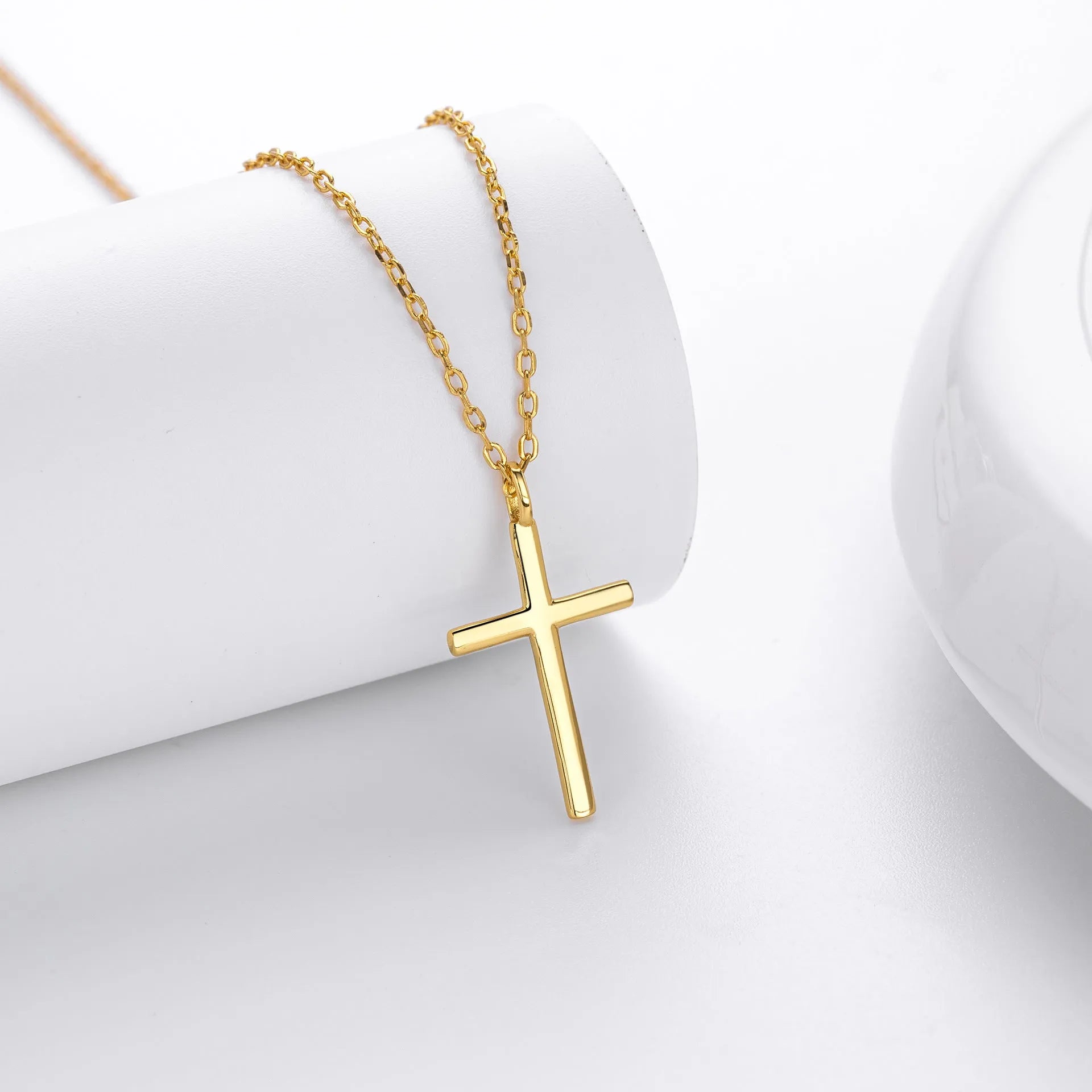 Simple glossy cross pendant on an adjustable O-shaped sterling silver chain.