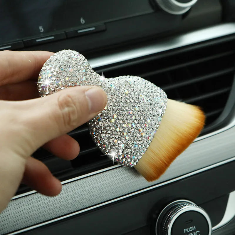 Compact white PVC soft-bristle brush for cleaning car dashboard vents and interior dust.