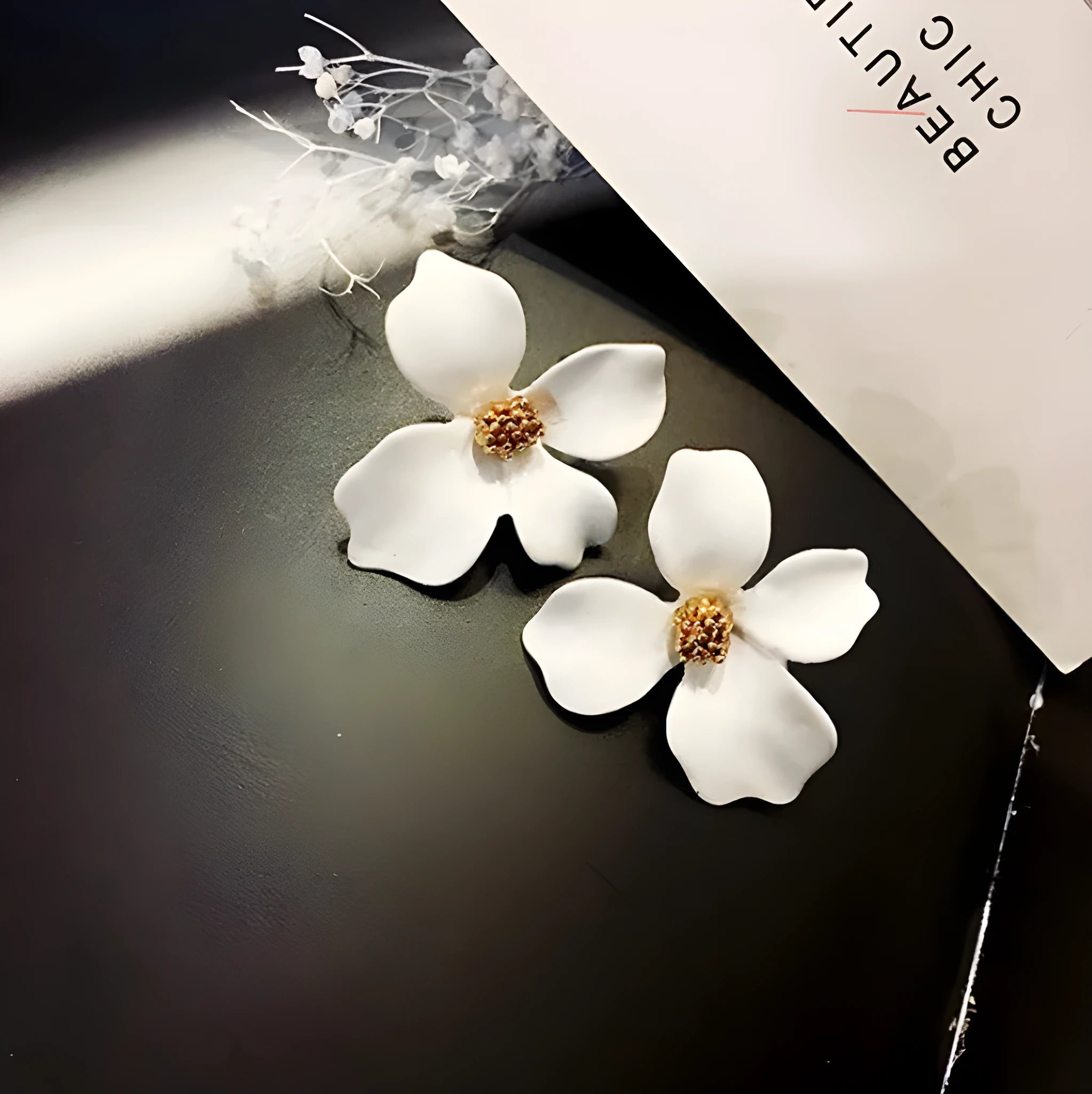 Women's floral stud earrings in white or pink electroplated alloy with flower shape design