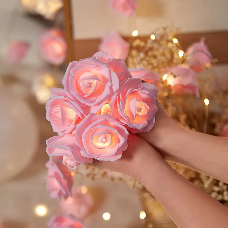 Battery-powered LED fairy lights with ten pink PV foam roses on a 1.5-metre wire for indoor decoration.