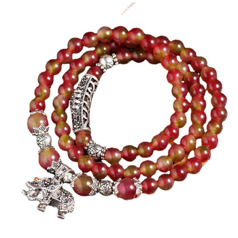 Handmade bracelet with geometric watermelon crystal beads and a Chinese knot closure.