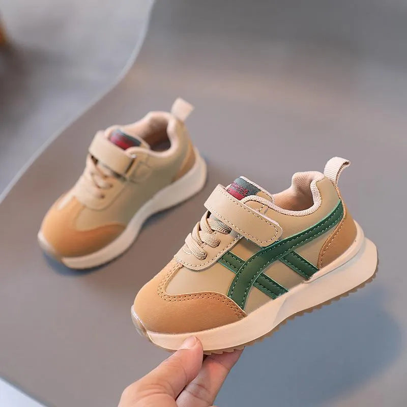 Children's solid-colour sneaker with Velcro strap, shown in beige, on a rubber sole.