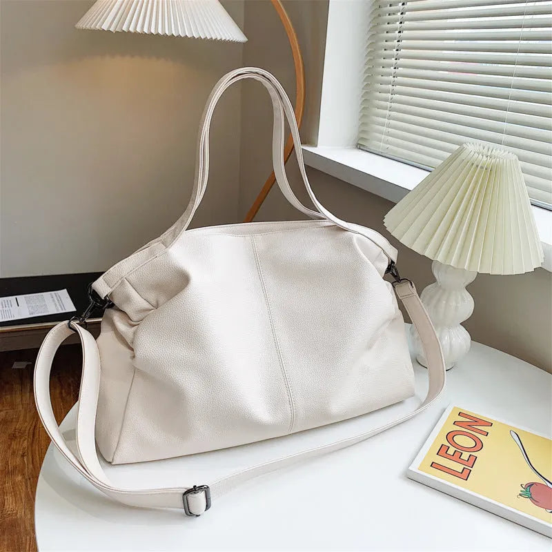 Large khaki soft PU messenger bag with long strap, shown open with internal phone and zipper pockets.
