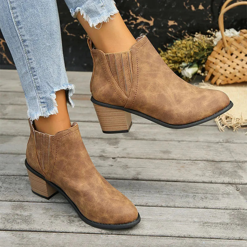 Black women's ankle boot with pointed toe and thick square low heel, slip-on design