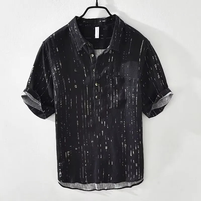 Man wearing a loose-fit black short-sleeve polo shirt, a summer casual style.