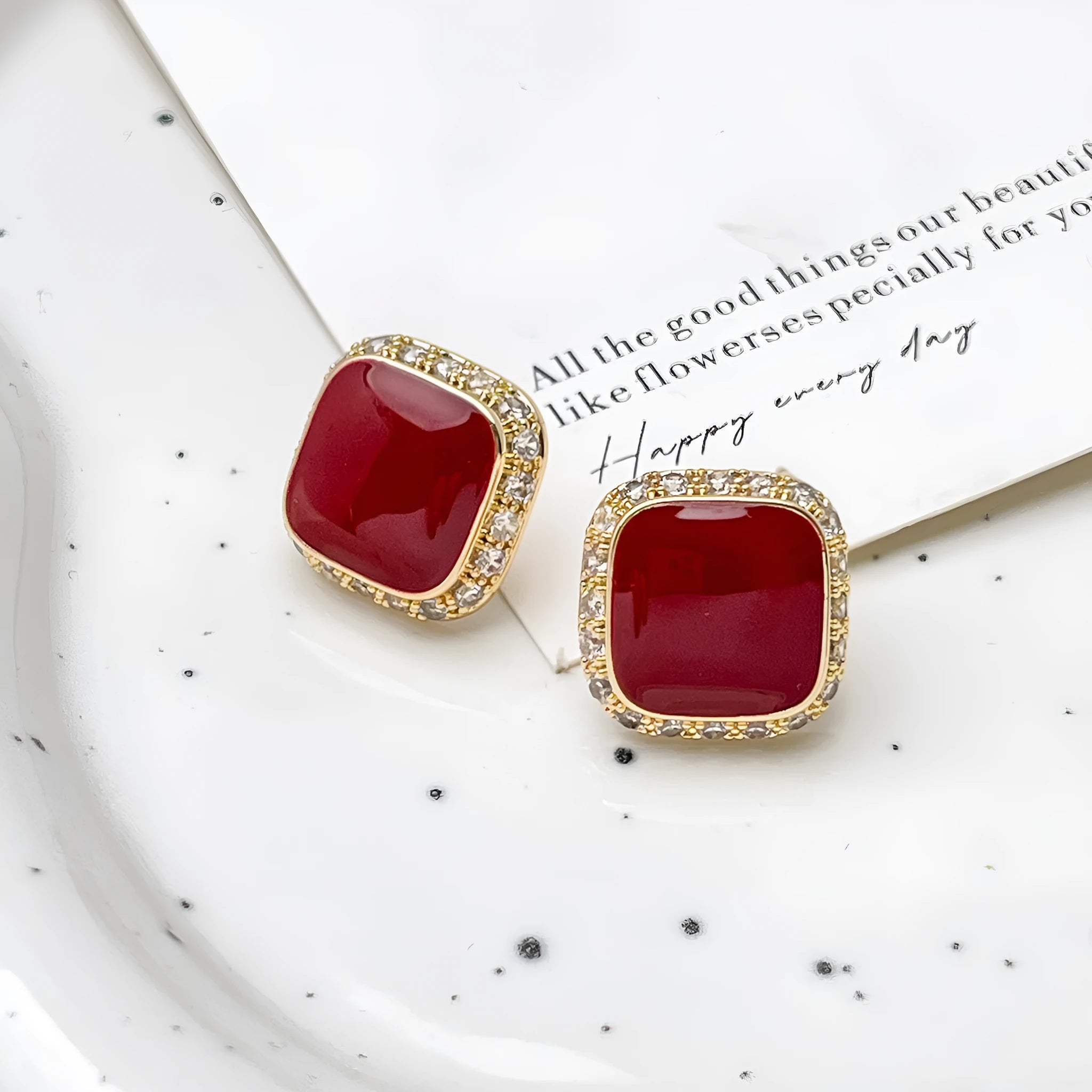A pair of red geometric square alloy earrings with an inlaid plate design, showing front view.