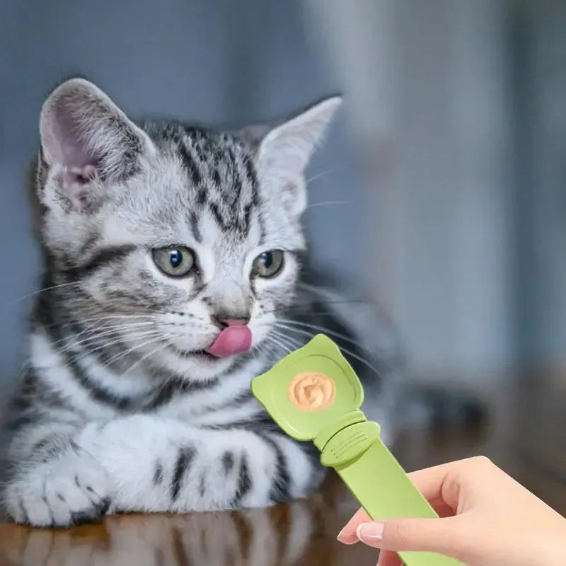 Cat Treat Spoon in green, orange, and white, measuring 27 x 6.5 cm, designed for scooping and serving cat strips