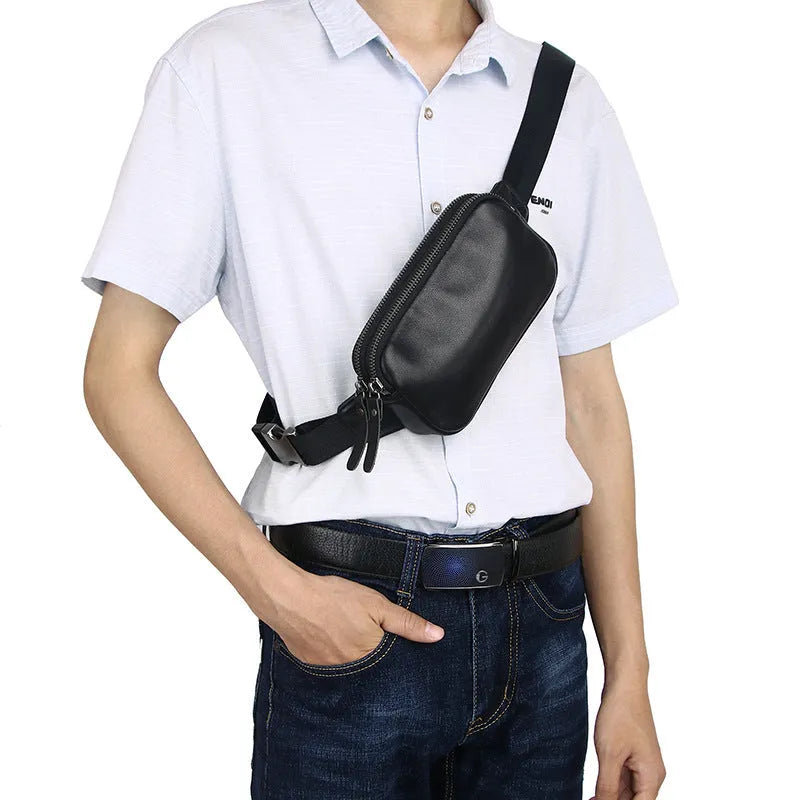 Men's small leather crossbody bag in black showing 17cm width dimensions