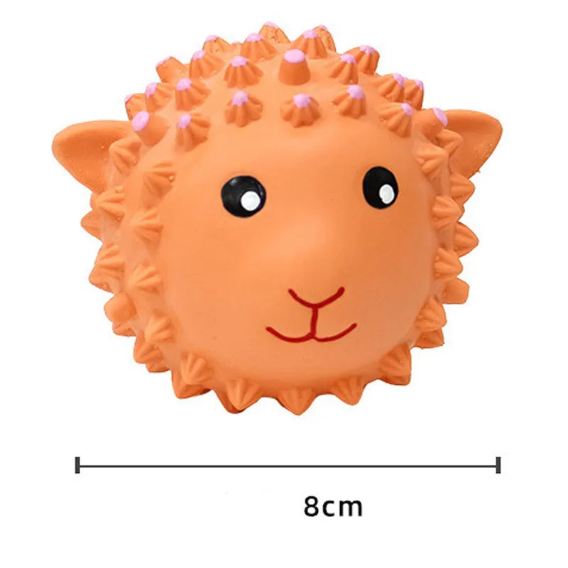 Orange and yellow spiky latex dog toy with animal design, shown next to a measuring tape showing 3 inch diameter.