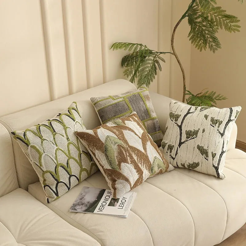 Close-up of a square Jacquard woven cushion cover with a detailed retro floral pattern in various colours.