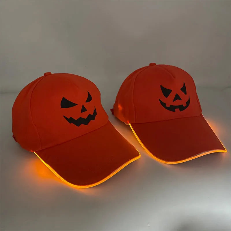 Black Halloween baseball cap with LED pumpkin smile face and yellow lights illuminated.