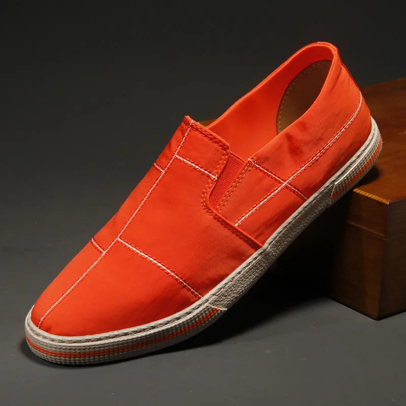 Men's low-top slip-on canvas shoes in various colours showing round toe and vulcanised rubber sole.
