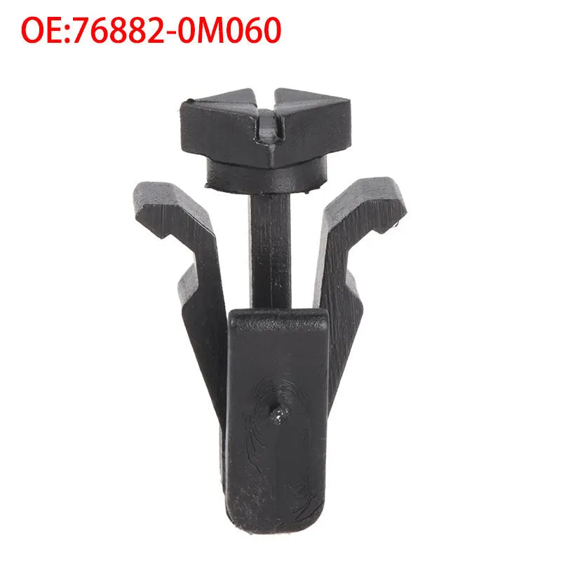 Black plastic automotive fastening clip for Nissan bumper or grille, part number 76882-0M060.