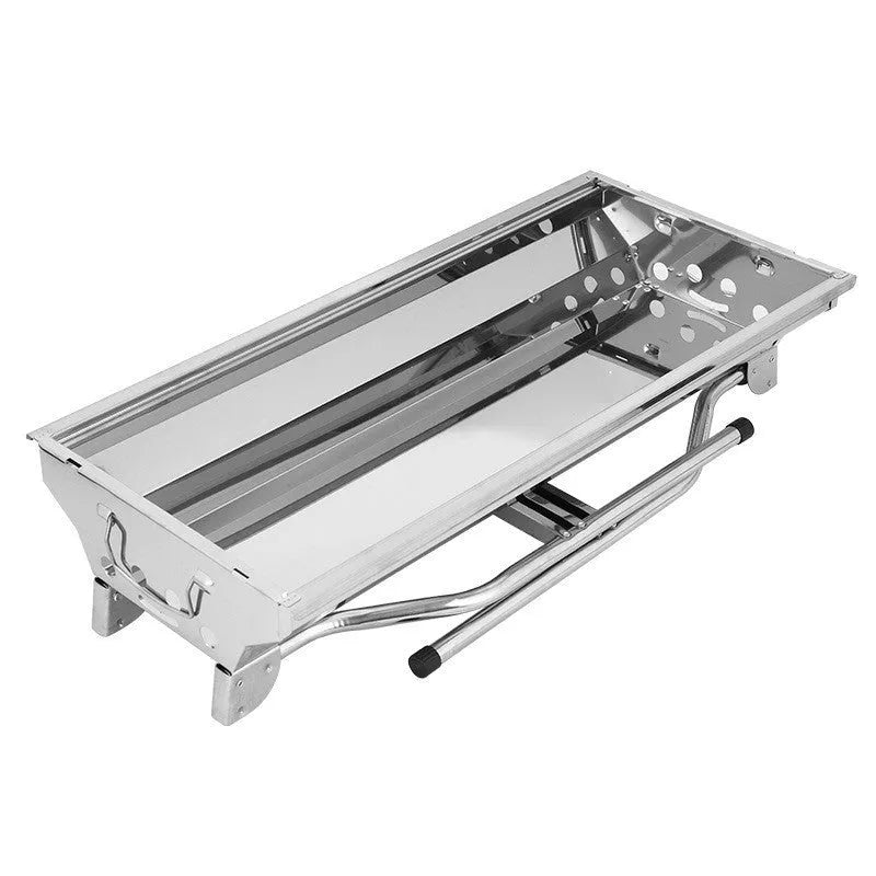 Stainless steel portable folding barbecue oven set up outdoors.