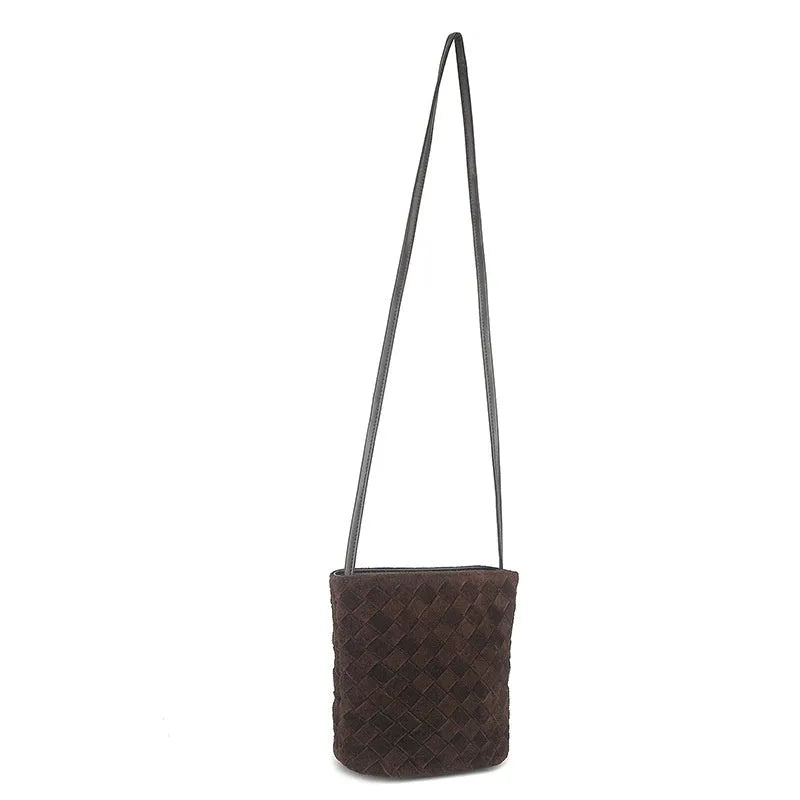 Cowhide leather barrel-shaped zip crossbody bag in black with weaving detail and crossbody strap