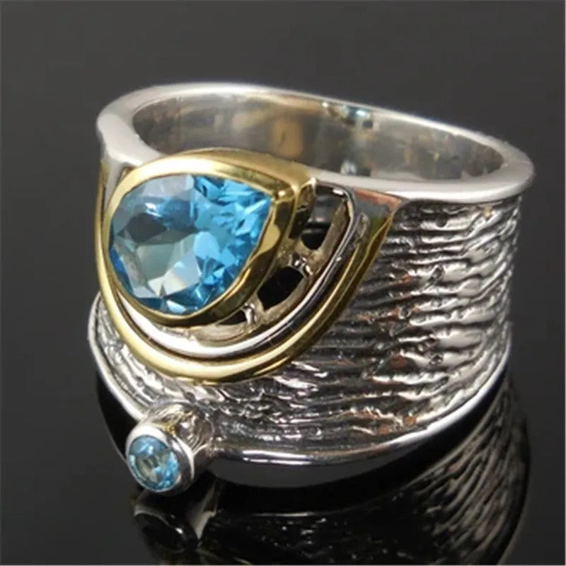 Blue zircon stone set in a drop-shaped alloy ring with Chinese style design.