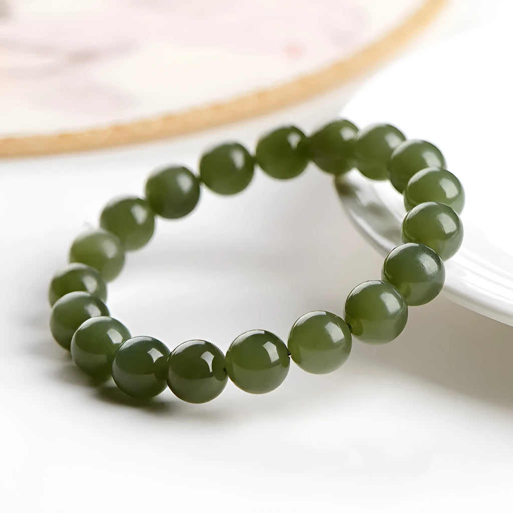A polished Hetian jade ball bracelet showing beads in a clear ice-like colour on a wrist.