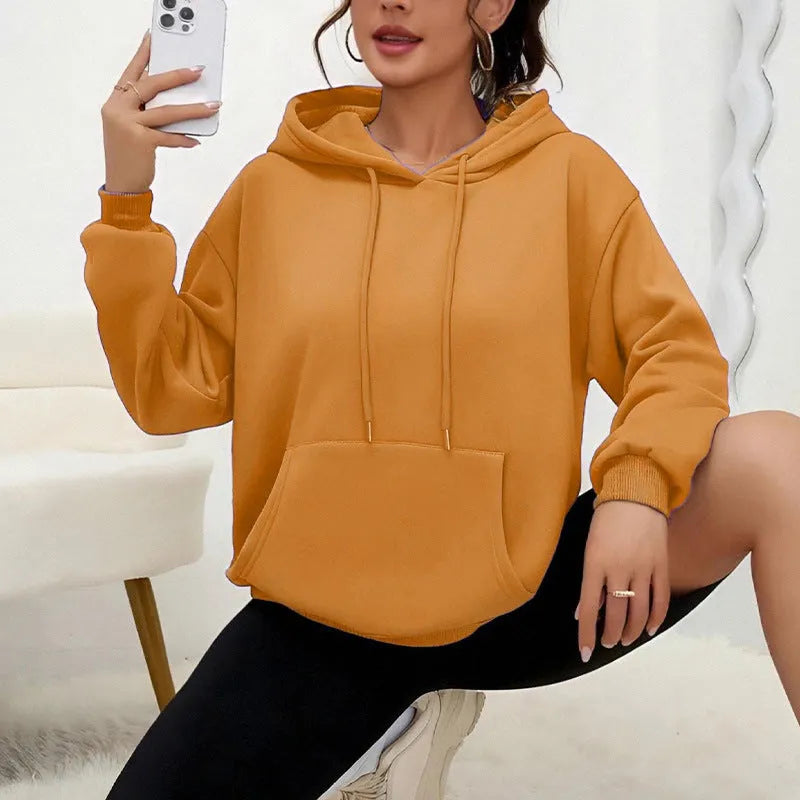 Women's loose grey sweatshirt with long sleeves and a front drawstring pocket.