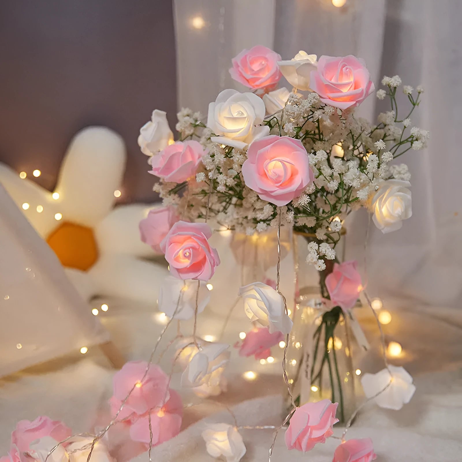 Battery-powered LED fairy lights with ten pink PV foam roses on a 1.5-metre wire for indoor decoration.