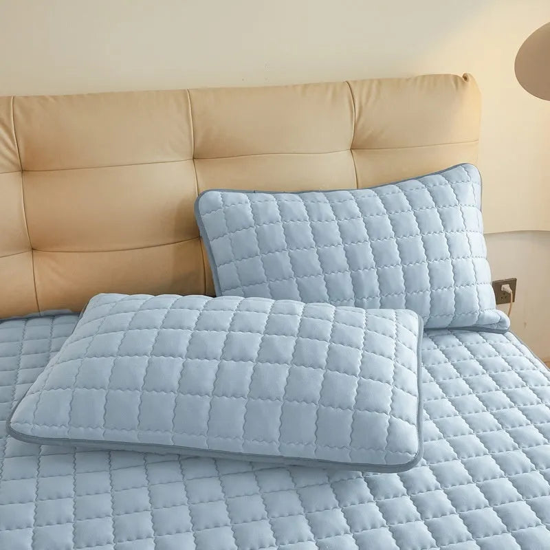 Blue waterproof fitted sheet with elastic corner stretched over a mattress.