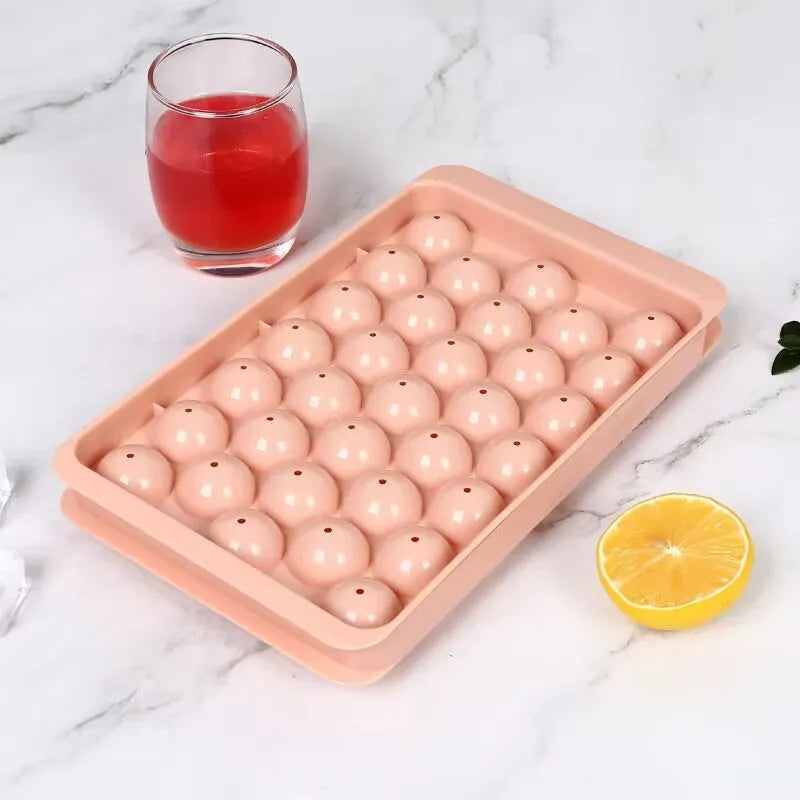 Blue silicone ice cube tray with lid showing 33 round cavities.