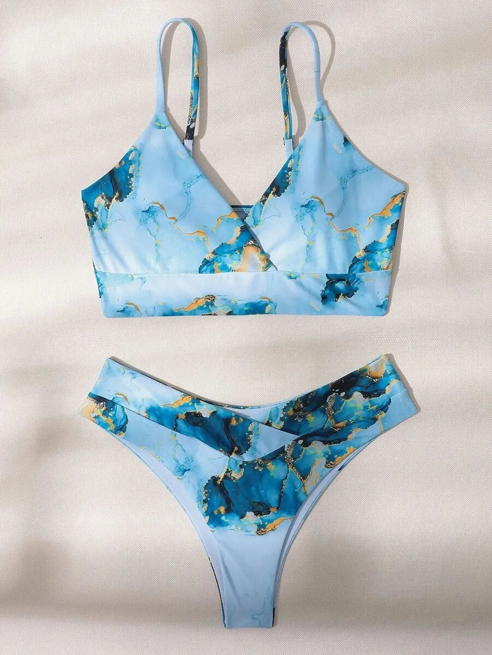 Women's high waist bikini set in a marble tie-dye print, showing U-neck top and briefs.