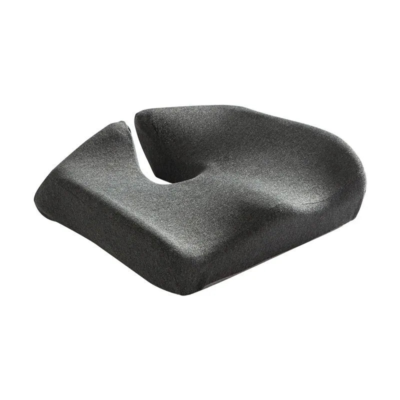 Black memory foam office chair cushion for waist support, shown on a desk chair.