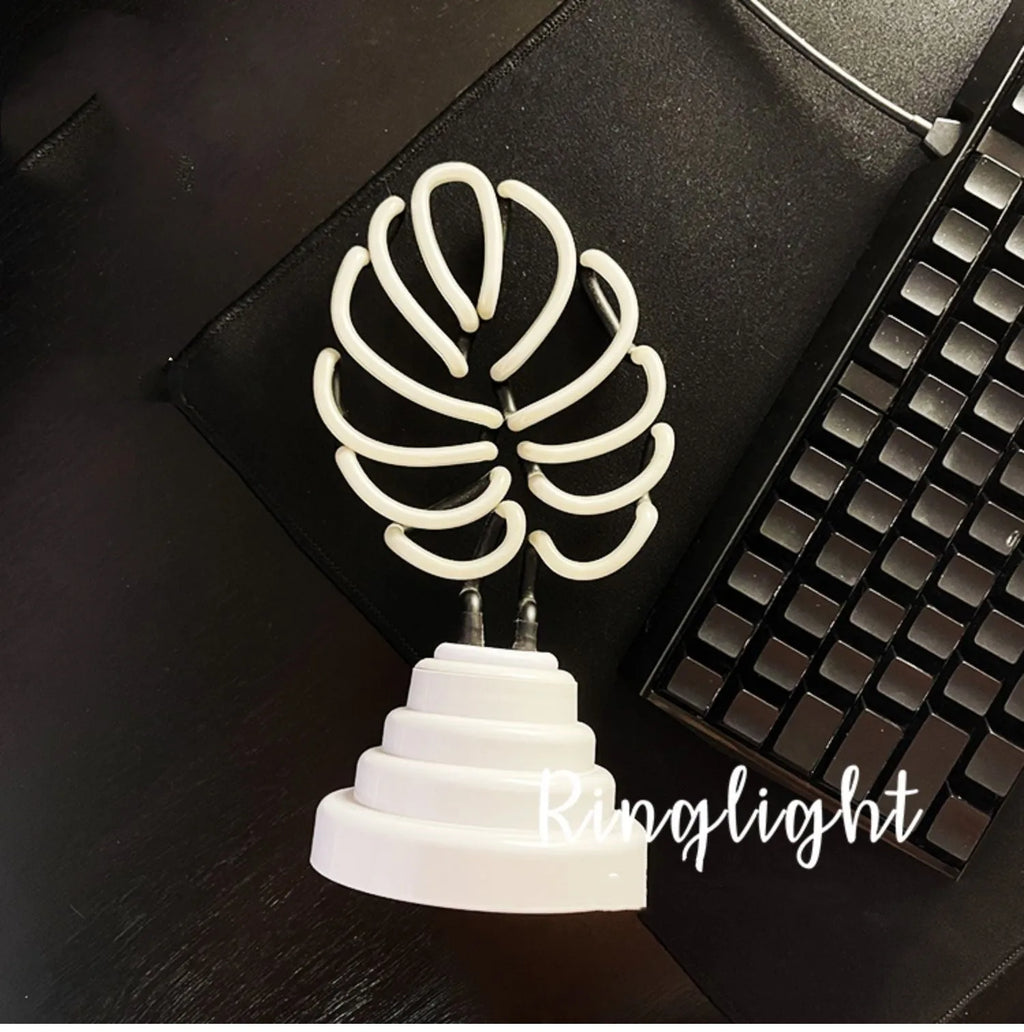 Handmade white bamboo-shaped desk lamp emitting green light, shown in two size options.