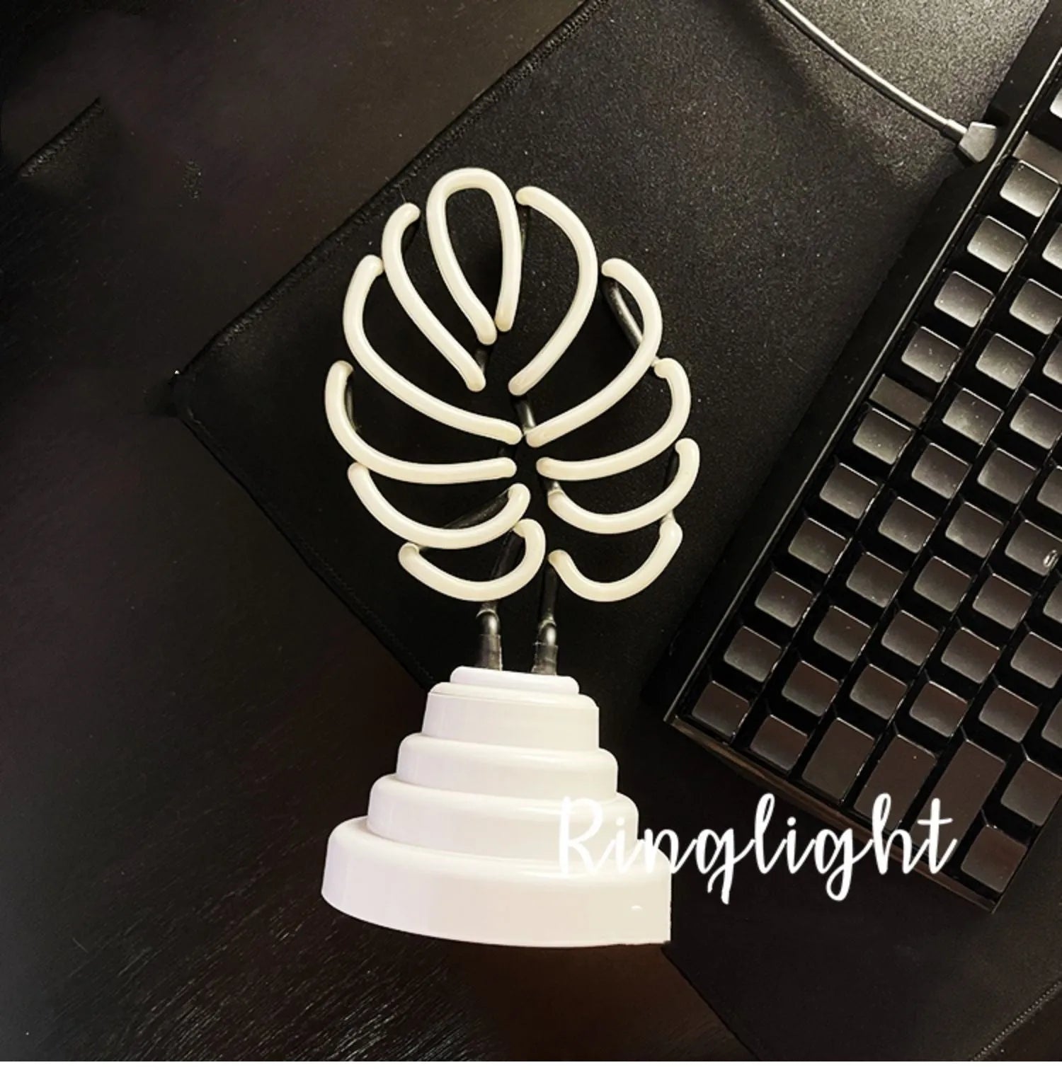 Handmade white bamboo-shaped desk lamp emitting green light, shown in two size options.