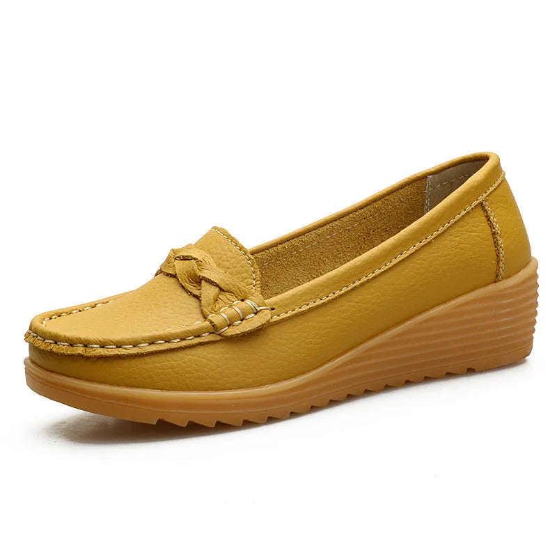 Women's cowhide Gommino soft bottom wedge heels in round toe style with genuine leather upper on display