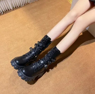 Women's black mid-calf knight boots with a large metal buckle and side zip.