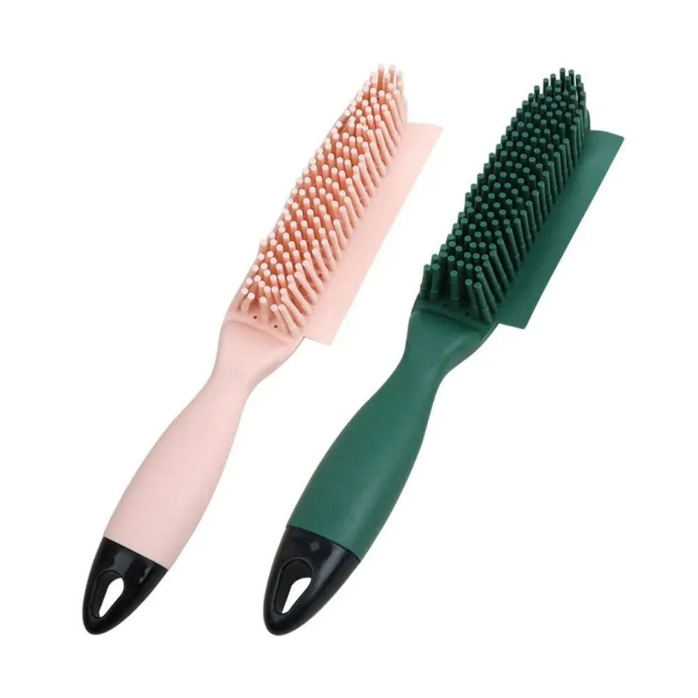 Pink and green handheld pet hair remover brush with grooming comb and integrated clothes hair collector.