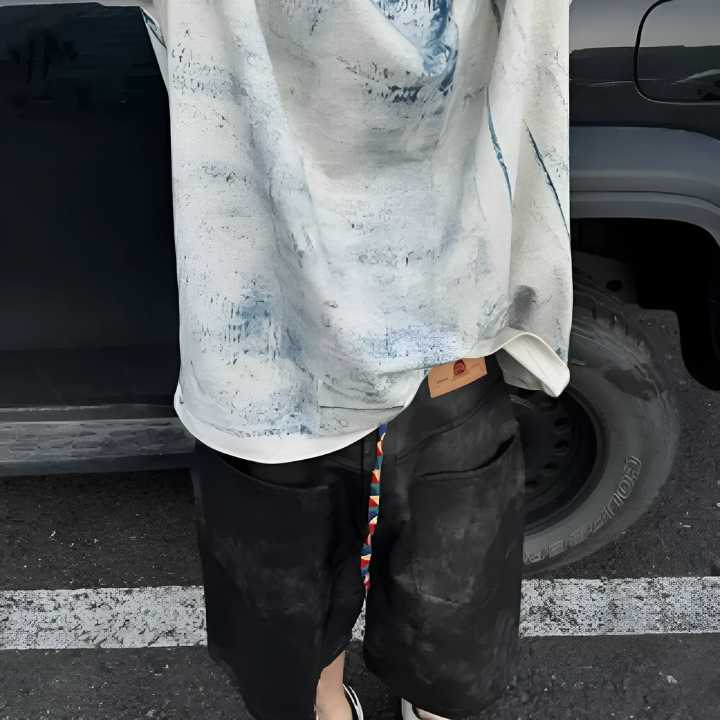 Man wearing a loose-fit Korean-style T-shirt with a dirty print effect and round neck.