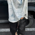 Man wearing a loose-fit Korean-style T-shirt with a dirty print effect and round neck.
