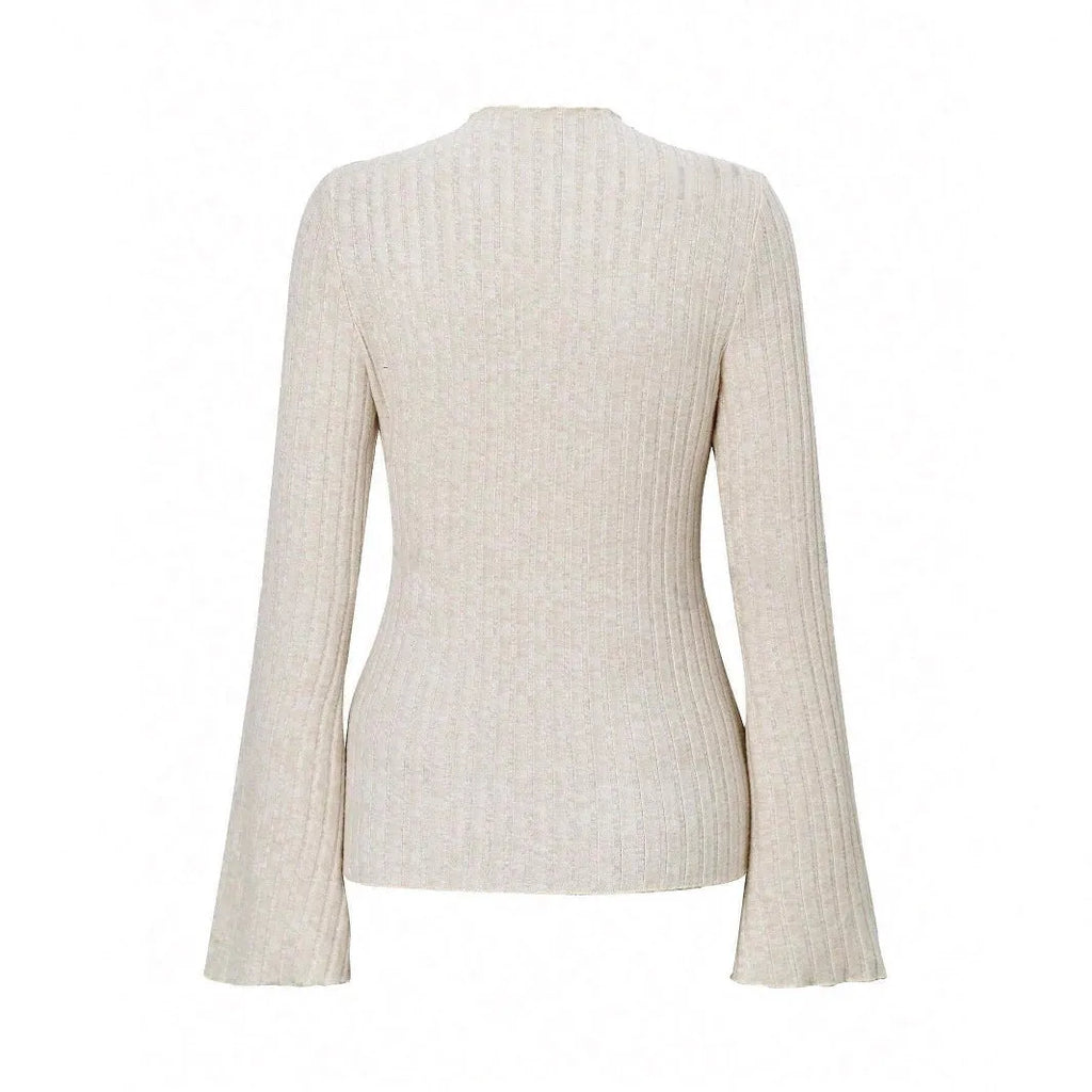 Slim-fit long-sleeve top in black with sunken stripe texture and lantern sleeves on a hanger.
