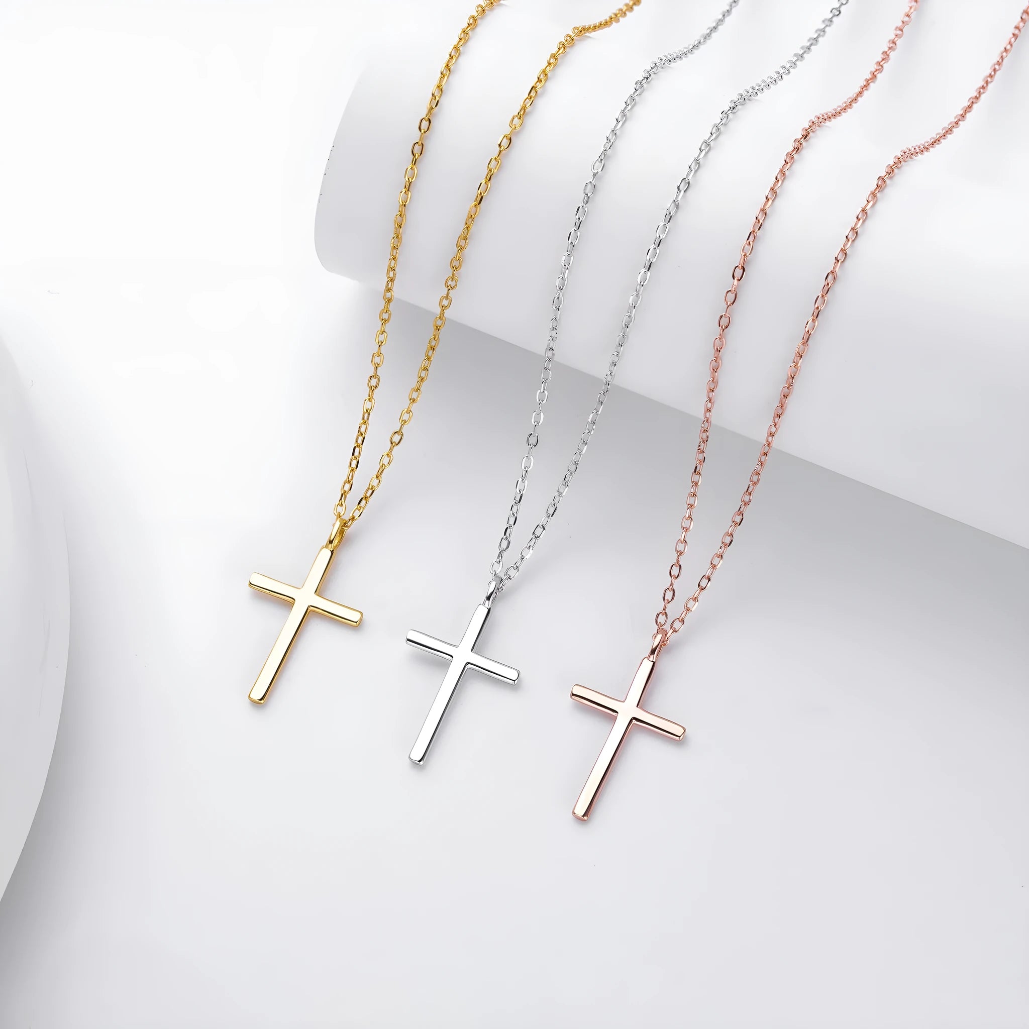 Simple glossy cross pendant on an adjustable O-shaped sterling silver chain.
