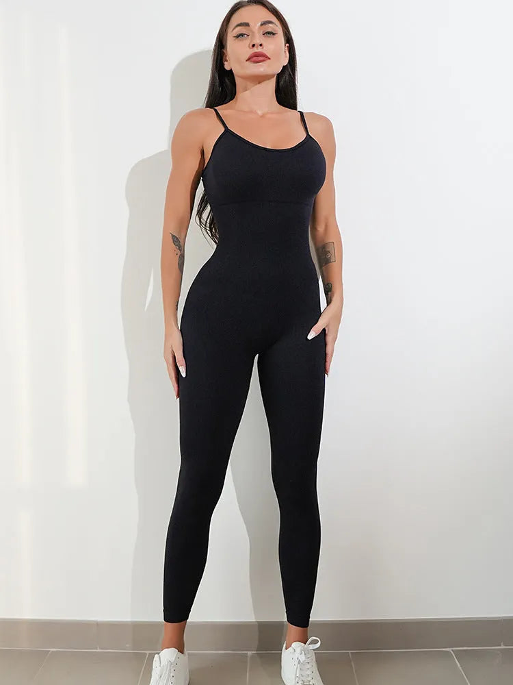 Women's black sleeveless unitard jumpsuit with spaghetti straps and a backless design.
