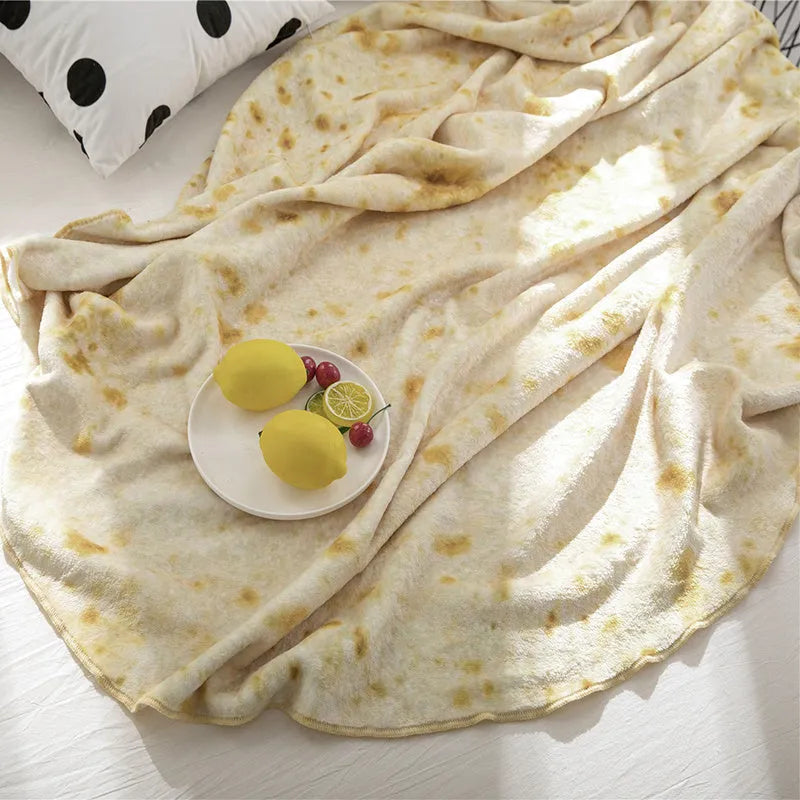 Round coral fleece burrito blanket with food print, shown in a folded pile.