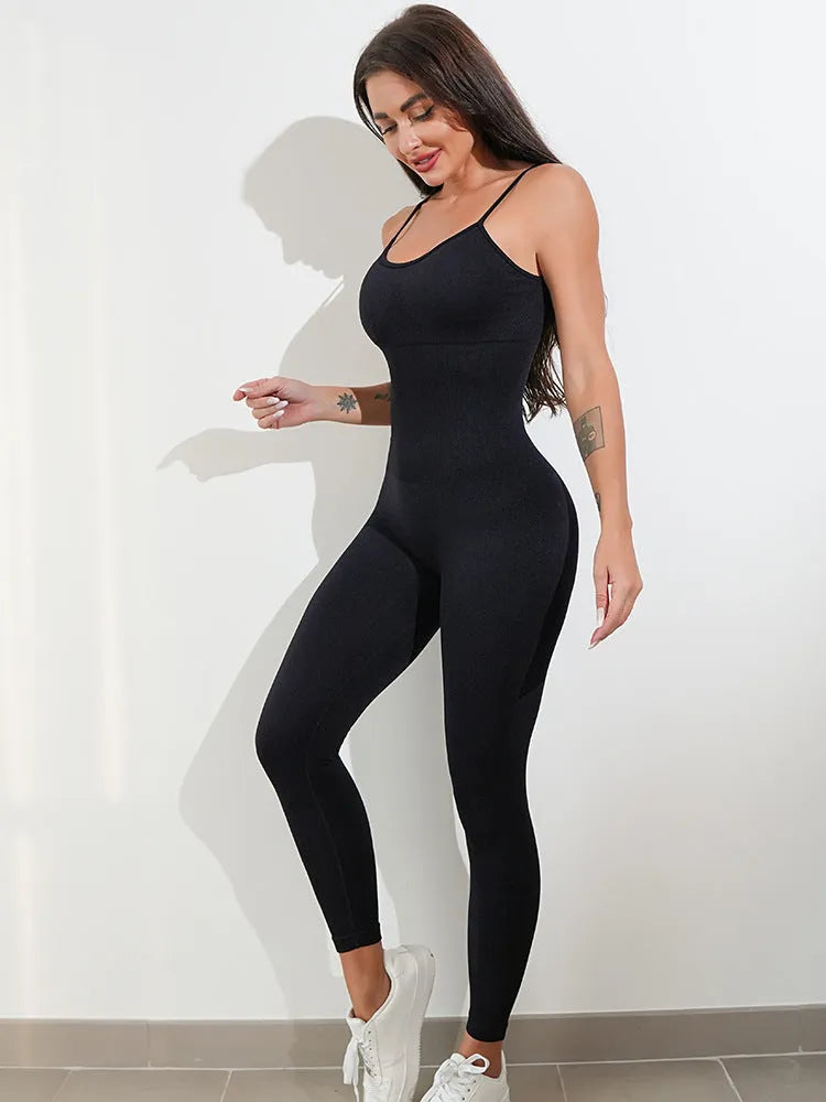 Women's black sleeveless unitard jumpsuit with spaghetti straps and a backless design.