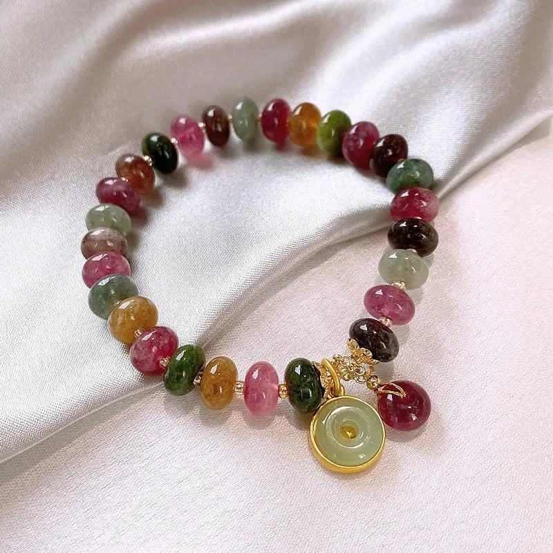 Colourful tourmaline abacus bead bracelet with rabbit pendant charm on wrist