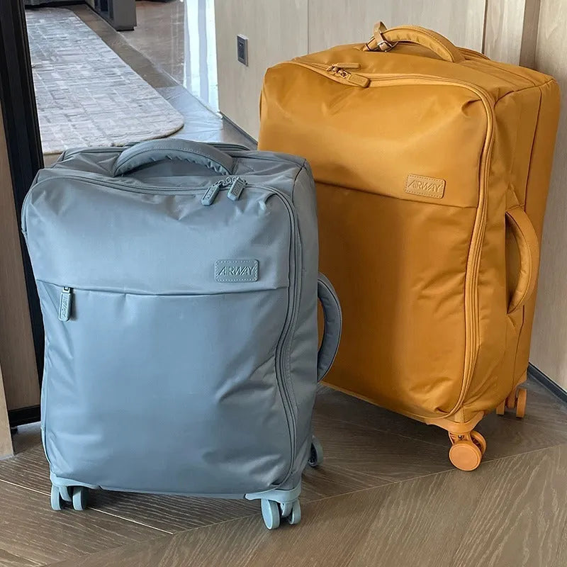 Waterproof Oxford cloth suitcase with universal wheels in six colour options including tea brown and haze blue