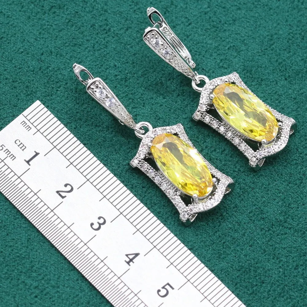 Yellow anti-allergy zircon jewellery set with snake bone chain necklace, earrings, ring, and bracelet on display.