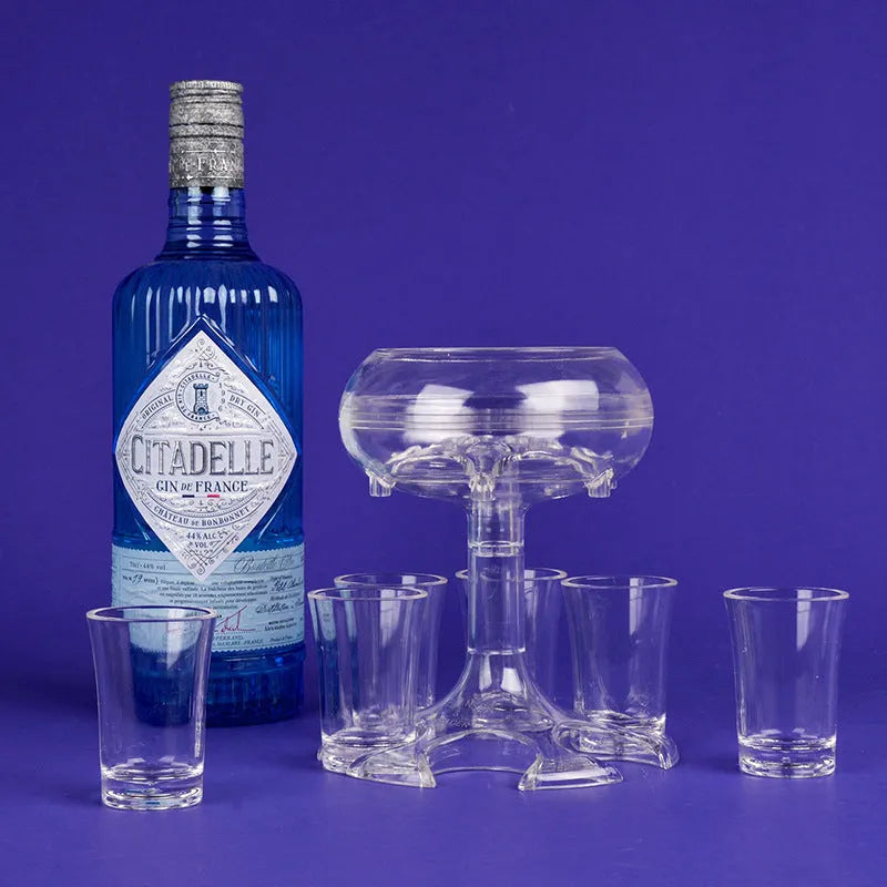 Transparent Plexiglass 6-shot glass dispenser rack holding six cups on a stand.