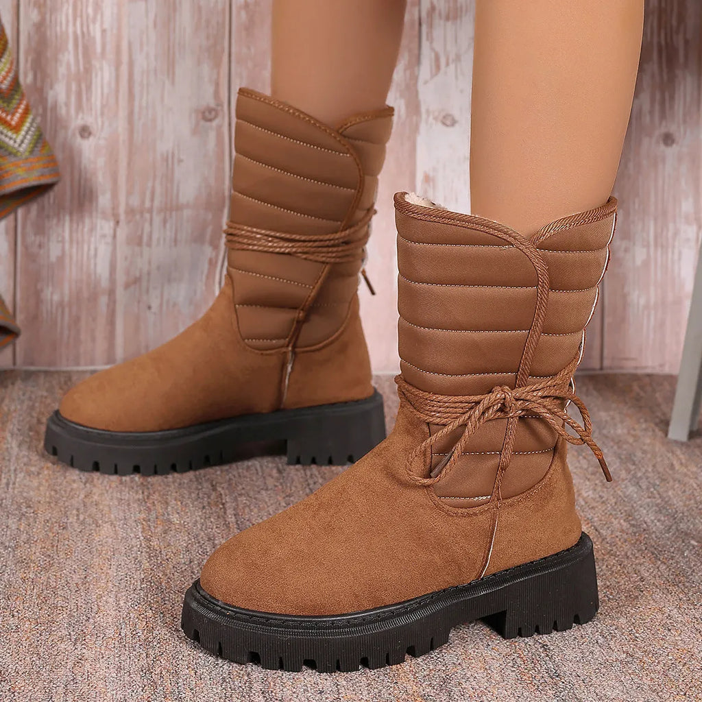 Women's black suede snow boots with chunky heel, fleece lining, and lace-up design.