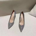 Silver and black women's wedding shoes with crystal detail and stiletto heel.