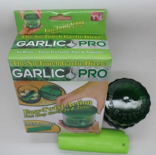 Green transparent plastic garlic peeler kitchen gadget on a countertop.