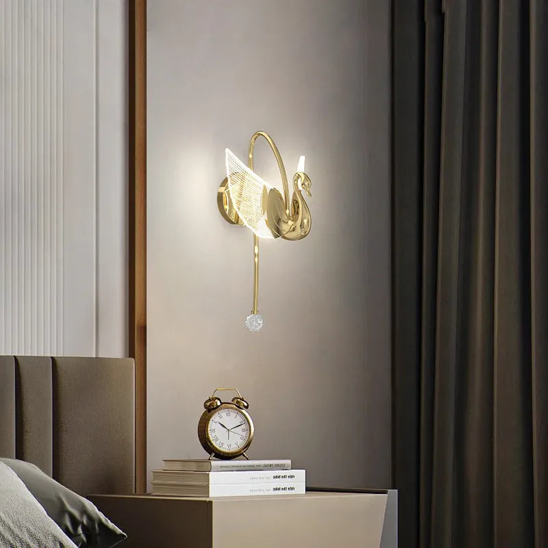 Gold modern swan-shaped wall lamp with an acrylic shade and dimmable LED light.
