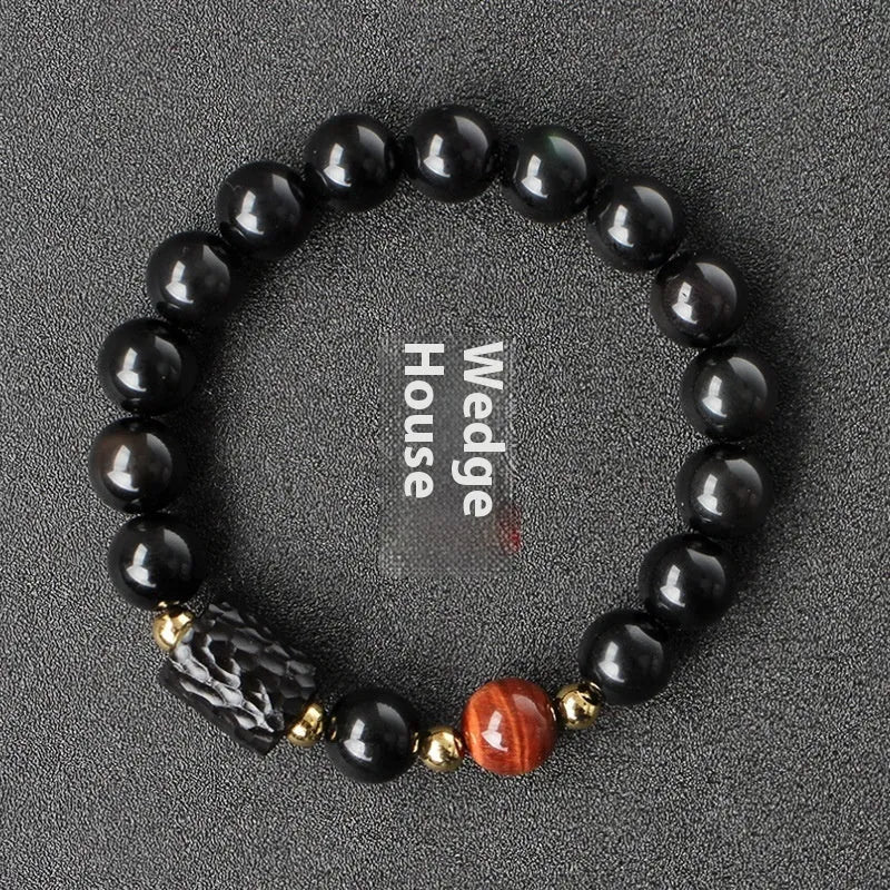 Obsidian bracelet with yellow tiger eye beads showing retro circular design