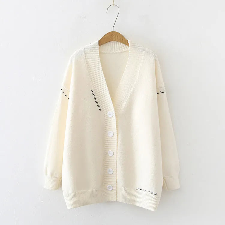 Women's loose-fit black knitted cardigan top coat with long sleeves on a hanger.