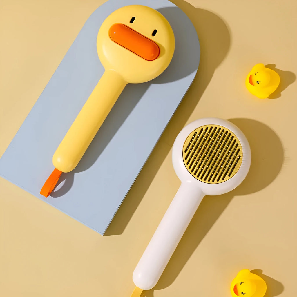 Small yellow duck-shaped pet grooming comb with open sections for cats and dogs